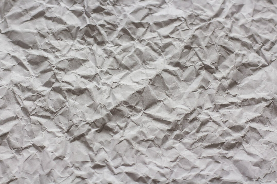 Abstract folded paper texture in soft neutral tones