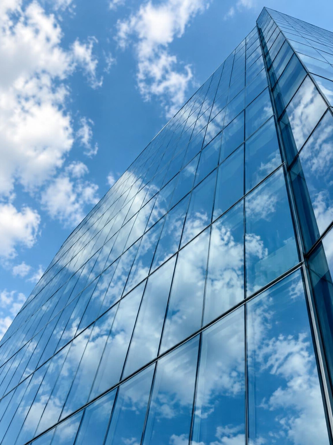Clouds reflected on a glass building facade